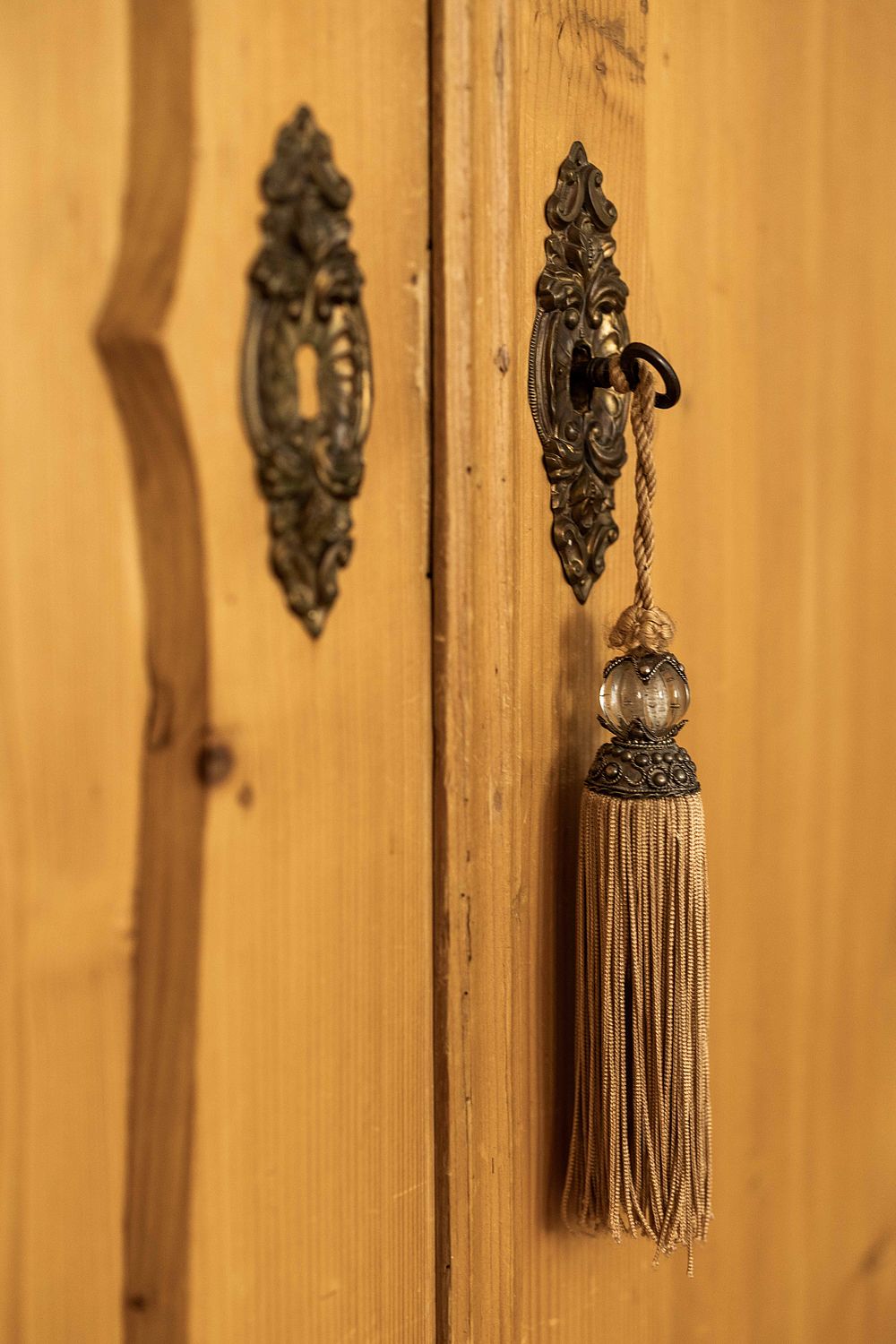 Antique key in the lock of a country style wardrobe