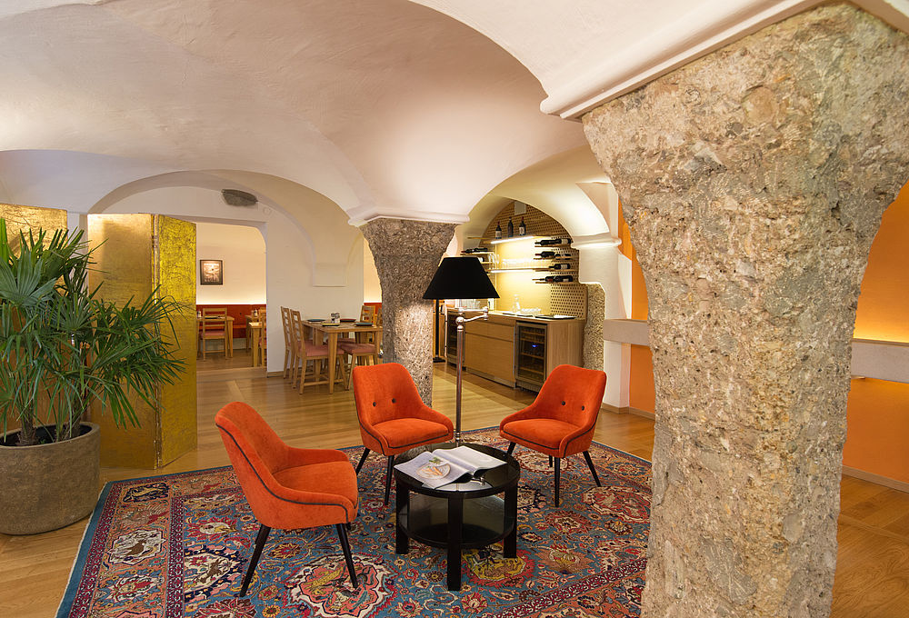 Hotel lobby in orange tones and with palm tree in the city of Salzburg 