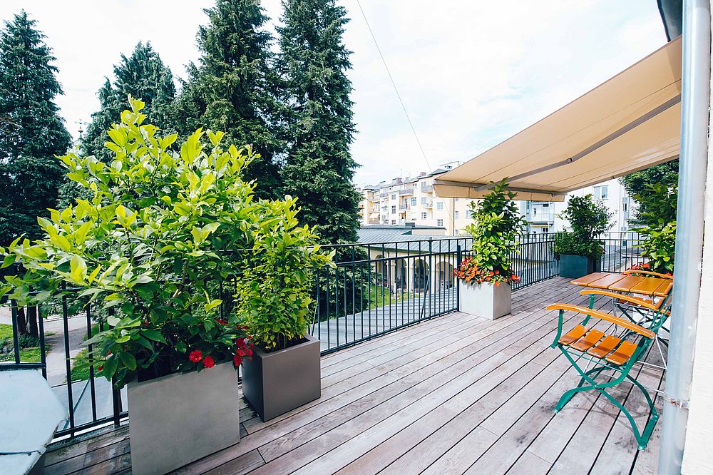 Romantic sun terrace of the Hotel Amadeus with a view of the historic St. Sebastian's Cemetery