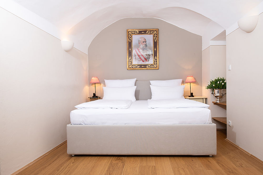 Blick auf das blütenweiße Bett der Junior Suite im Hotel Amadeus